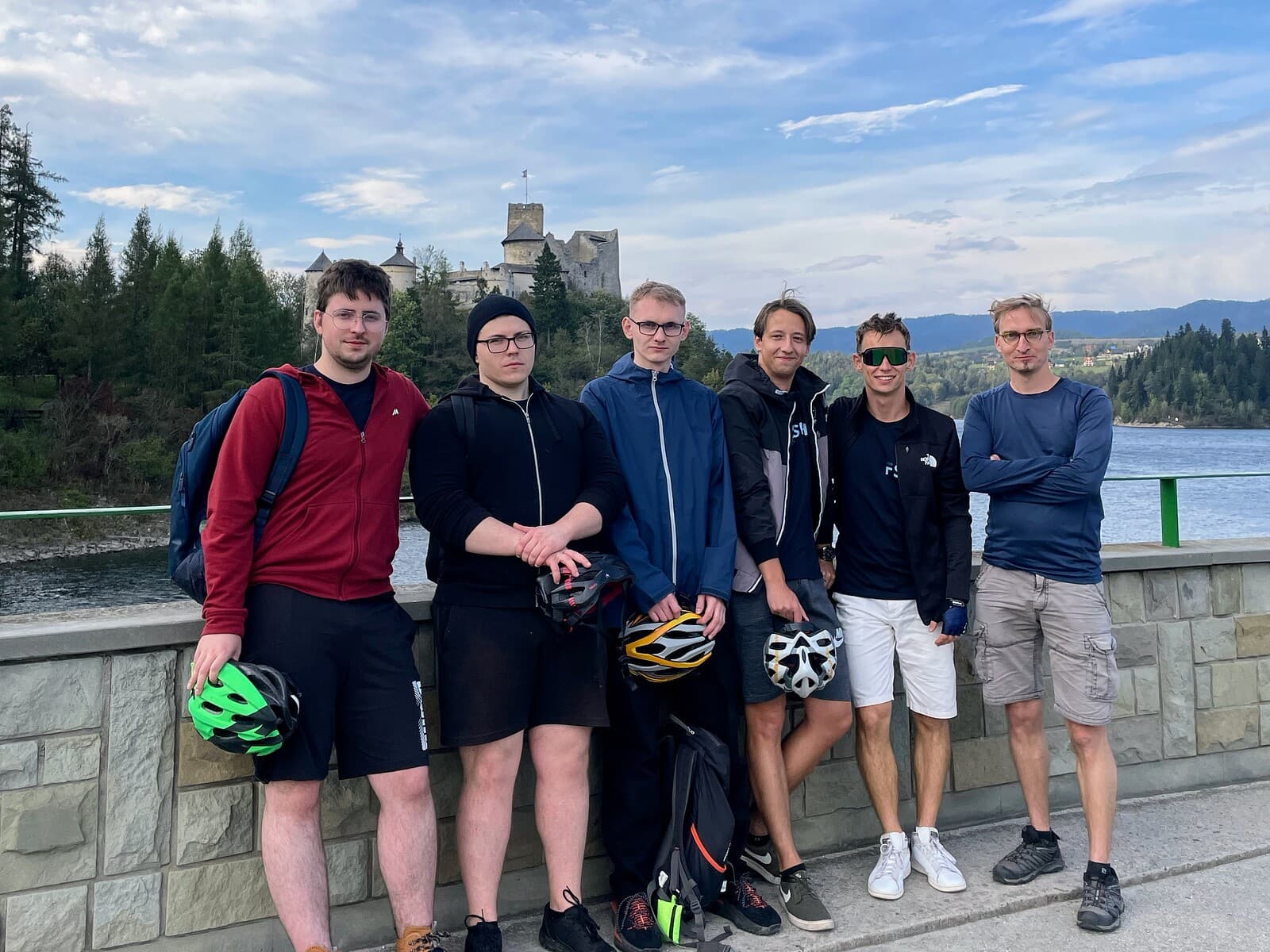 The team in front of a castle and lake on an offsite